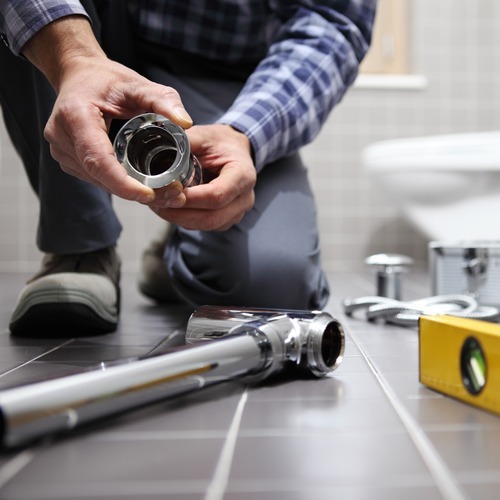 plumber working in a bathroom